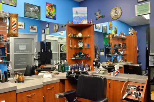 An image of the barbershop, with a barbers chair, products, and tools.