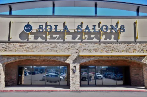 The facade of Sola Salons building with a large sign that reads 'Sola Salons'